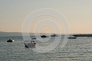 Golden Hour Serenity: Small Boats in Sea at Sunset