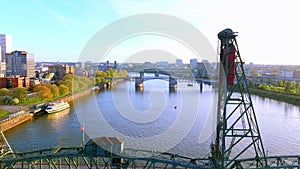 Golden hour tilt-up and flyover aerial view at the Hawthorne Bridge, downtown Portland, Oregon, with River Cruise Ship