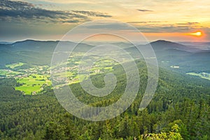 Golden hour view from mount Osser to Lam, a small town in the Bavarian Forest. Mount Hohenbogen on the right