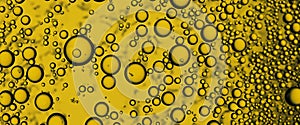 Golden Hyaluron Oil bubbles collagen serum or yellow oil bubbles drop texture background