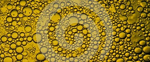 Golden Hyaluron Oil bubbles collagen serum or yellow oil bubbles drop texture background