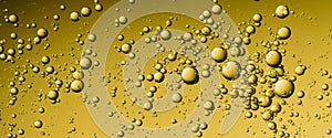 Golden Hyaluron Oil bubbles collagen serum or yellow oil bubbles drop texture background