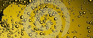 Golden Hyaluron Oil bubbles collagen serum or yellow oil bubbles drop texture background