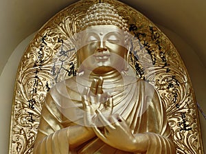 Golden idol of Japanese Lord Buddha sitting in meditative position worshipped by Buddhists around the globe. Siddharth is sacred i photo