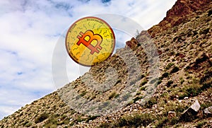 Golden illustrated bitcoin coin rolls down the mountain