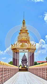 Golden Independence monument, Naga bridge walk way through the monument with beautiful clouds and blue sky background, Ta Keo, Cam