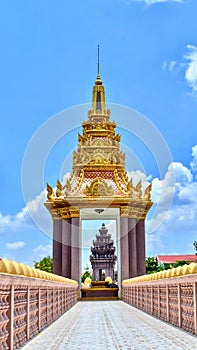 Golden Independence monument, Naga bridge walk way through the monument with beautiful clouds and blue sky background, Ta Keo, Cam