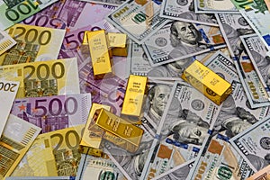 Golden ingot on american dollars and euro banknotes