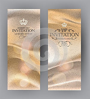 Golden invitation cards with silk fabric on the background.