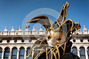 Golden jester mask at Venice Carnival