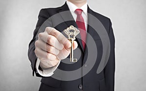 Golden key in businessman hand