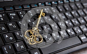 Golden key symbol on black computer keyboard