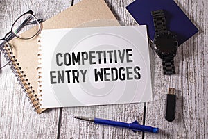 golden key. text Competitive Entry Wedges on black business card