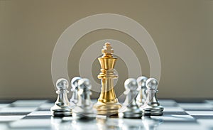 Golden King Chess is surrounded by silver chess, in conceptbusiness, triumph, success and competition. On board chess with a