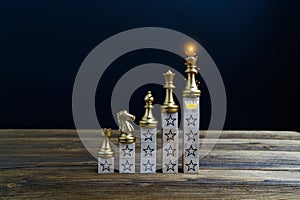 Golden king of chess on top with crown and star