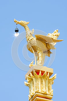 Golden kinnari statue on blue sky