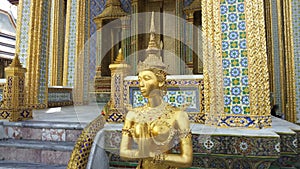 Golden Kinnari statue at Temple of Emerald Buddha Wat Phra Kaew in Grand Royal Palace , Bangkok Thailand