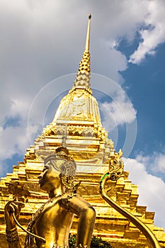 Golden Kinnari statue at Temple of Emerald Buddha (Wat Phra Kaew) in Grand Royal Palace. Bangkok, Thailand