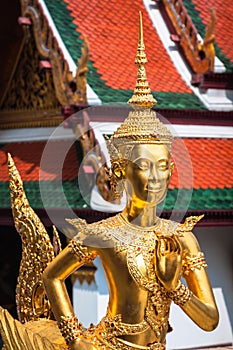 Golden Kinnari statue at Temple of Emerald Buddha (Wat Phra Kaew) in Grand Royal Palace. Bangkok, Thailand