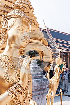 Golden Kinnari statues in Grand Palace in Bangkok