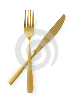 Golden knives and forks set against a white background. Gold cutlery. Beautiful gold cutlery