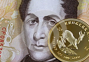 A golden krugerrand against a 100 Venezuelan Bolivares bank note photo