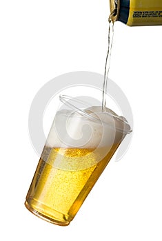 Golden lager or beer in disposable plastic cup