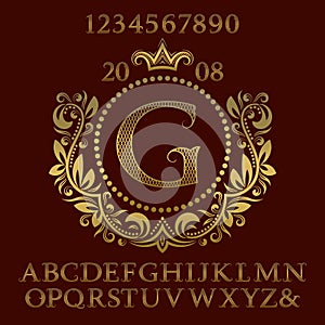 Golden lattice patterned letters and numbers with initial monogram in coat of arms form. Decorative font and elements kit for logo