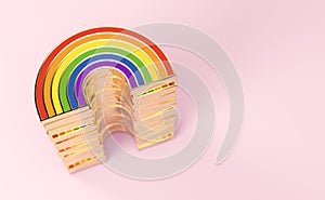 Golden LGBTQ rainbow pile for gay pride, LGBT, bisexual, homosexual symbol concept. Isolated on pastel pink background with copy photo
