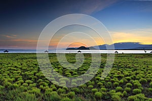 Golden light above Mount Rinjani as seen from Kenawa Island, Sumbawa, Indonesia photo