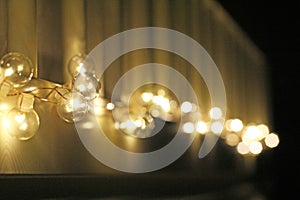 Golden light bulbs on the night dark background. City lights. Bokeh soft abstract background. Bokeh - Image