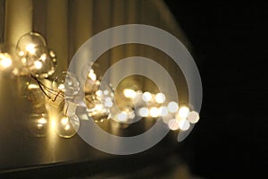 Golden light bulbs on the night dark background. City lights. Bokeh soft abstract background. Bokeh - Image