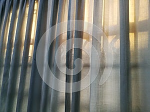 Golden light through curtain in the morning.  Full frame shot of transparent curtain and sunlight in the morning.
