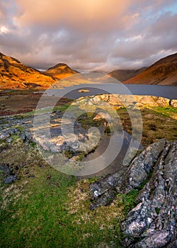 Golden light on rocks at Wastwater, Lake District, UK.