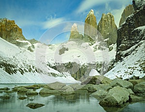 Golden light shining on towers of Torres del Paine Chile