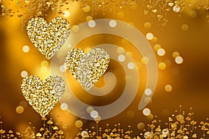 Golden lights in the shape of hearts in the defocus on a dark background. Celebrating Valentine`s Day,gold blurred background with