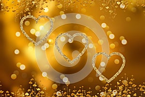 Golden lights in the shape of hearts in the defocus on a dark background. Celebrating Valentine`s Day,gold blurred background with