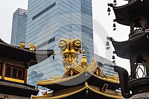 Golden lion statue on the root of Jing an Temple the temple in the shanghai city