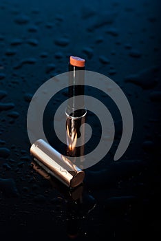 Golden lipstick with water drops