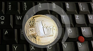 Golden Litecoin LTC  coin over  a black laptop  keyboard