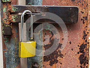 Golden lock at the rusted steel door