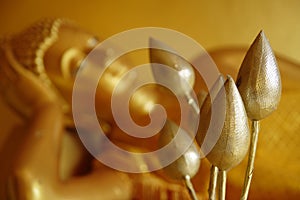 Golden lotus at front of Buddha statue photo
