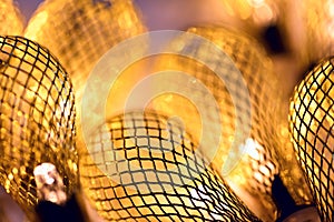 Golden macro background - lighted retro garland lights. Festive mood close-up background