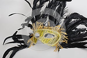 Golden mask venetian with black feathers from the side