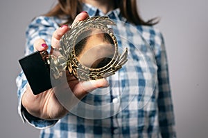 Golden medal award trophy in female hand