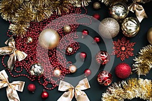 Golden Merry Christmas and Happy New Year Decoration. Red and gold Bauble on Christmas black background. Winter time