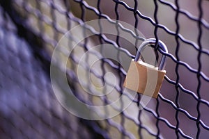 Golden metal padlock on grill