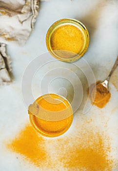 Golden milk with turmeric powder in glasses, natural health boosting