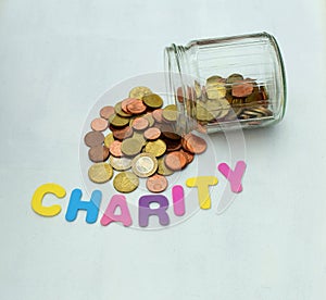 Golden money coins in a glass jar - charity, donation concept