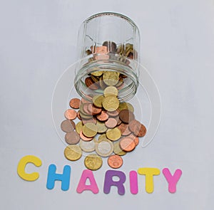 Golden money coins in a glass jar - charity, donation concept